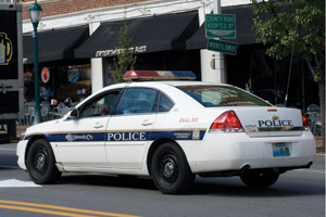 A University City Police Office patrols the Loop in his squad car Sept. 22. In response to increased crime, local police departments have stepped up the number of patrols in the area. (Mariam Shasavarani | Student Life)