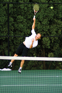 Junior Max Woods hits a serve in his match on Saturday at the ITA Central Regionals. Woods teamed up with junior Isaac Stein to win the ITA Central Regional Doubles championship. (Jared Bullock | Student Life)