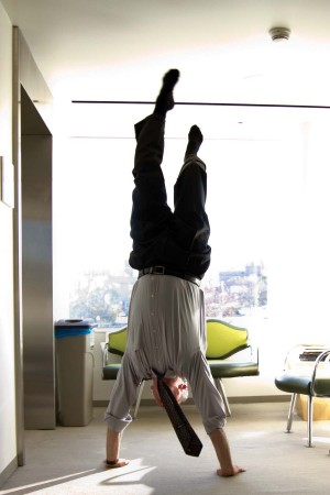 Professor Wallace does a handstand outside the Art  History office in Kemper.
