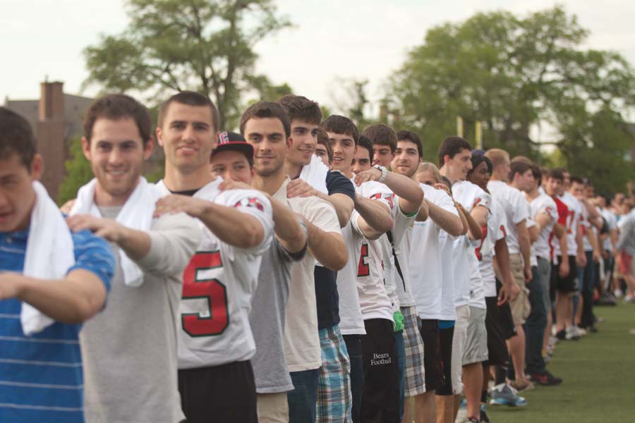 Students form a massage chain on Francis Field in an attempt to break a