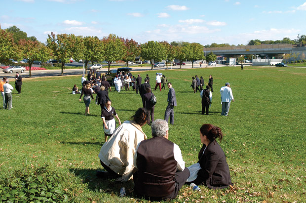 Ritz Carlton employees wait in a field on Oct. 16, 2008, after being evacuated from their building when a bomb went off in a nearby parking garage. (Matt Mitgang | Student Life)