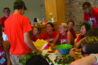 Leaders of the Launch pre-Orientation program welcome an incoming freshman in Ursa's Firesife. (Sam Guzik | Office of Orientation)