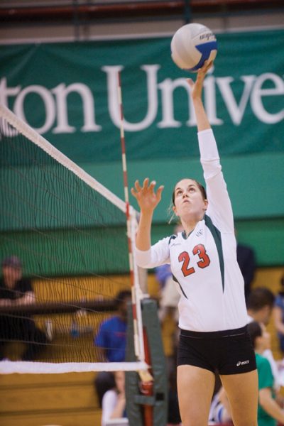 Senior setter Vicki Blood dumps the ball over the net against Greenville College in the Field House on Tuesday night. The Red and Green went on to win the match in three games. (Matt Mitgang | Student Life)
