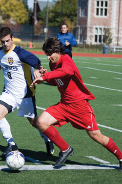 Sophomore forward Pat McLean pushes the ball down the field during an unfortunate 1-0 loss to University of Rochester on Sunday. (Daniel Eicholtz | Student Life)
