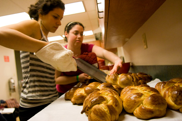 Current sophomores Hannah Schaffer and Elana Nemitoff prepare challah in the Mudd kitchens last year. Challah for Hunger, a social action group that sold challah to raise money for charity, has been unable to bake on campus this year because of health regulations. (Sam Guzik | Student Life)
