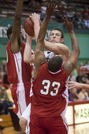 Junior Caleb Knepper goes up for the lay-up with two defenders on him in the regular season opener against MacMurray College on Sunday Nov. 15. Wash. U. won 88-53 as Knepper pulled down a career-high eight rebounds in his first collegiate start. (Matt Mitgang | Student Life)
