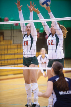 Senior Erin Albers and junior Marya Kaminski go up to block against Virginia Wesleyan College on Friday night. With three wins this weekend, the Bears earned the number one seed for the University Athletic Association championship next weekend in Chicago. (Matt Mitgang | Student Life)