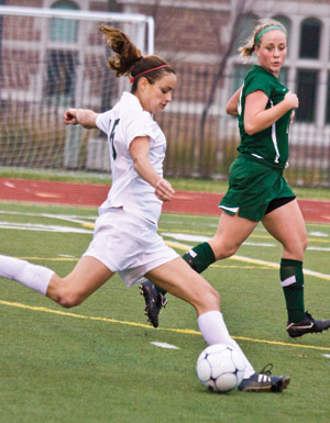 Senior midfielder Elyse Hanly clears the ball during the second half of Sunday's NCAA Division III Regional Final game. The game went into overtime at 0-0 with Hanly scoring the winning goal. The Bears will compete in the Sweet Sixteen versus Wheaton College this Friday. (Daniel Eicholtz | Student Life)