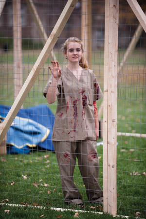  Sophomore Emily Piontek stands inside of a gulag created by Wash. U. Young Americans For Liberty. (Matt Mitgang | Student Life)
