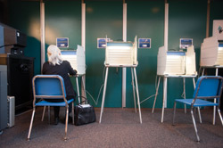 A voter casts her ballot at Wydown Middle School Tuesday afternoon as other booths sit empty. Turnout in St. Louis County was under 20 percent as voters overwhelmingly passed a smoking ban. (Matt Mitgang | Student Life)