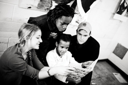 Current sophomore Sarah Schwartz (Left) and alum Clint Morgan (Right) with two of the kids at City Faces in February of last year. (Courtesy of Alwyn Loh)