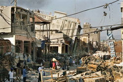 A burning building sends smoke over the earthquake ravaged Port-au-Prince, Haiti, Monday, Jan. 18, 2010. In response to the disaster, Student Union has launched a fundraising campaign to aid the victims of the earthquake, which has killed at least 70,000 people and affected millions. (Carolyn Cole | Los Angeles Times | MCT)