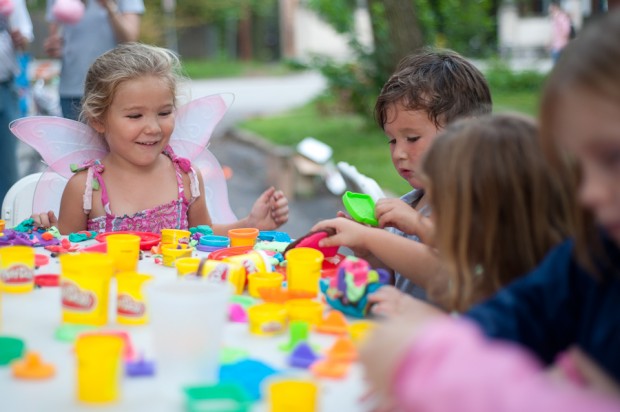 Children play at a Play-Doh table.