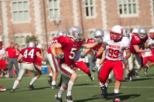 Freshman receiver Drew Sexton stiffarms a Wabash University defender on Saturday, Oct. 9. Sexton’s 38-yard reception in the fourth quarter set up a game-winning touchdown in the 14-13 victory over College of Wooster on Saturday, Oct. 16.  