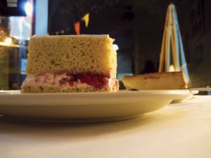 Tres leches cake with cream, milk, icing, and sprinkles. | Fritanga