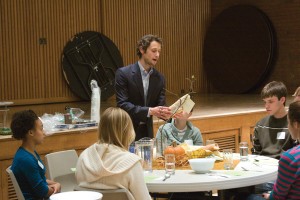 Rabbi Andy Kastner recites the blessing over bread before dinner began at Sacred Meals on Nov. 18.