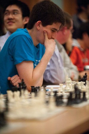Junior Mark Rosenberg considers his next move against Grandmaster Hikaru Nakamura on Saturday. Chellengers had a long time to consider their next move while Nakamura played the additional 41 players in the simul format challenge.