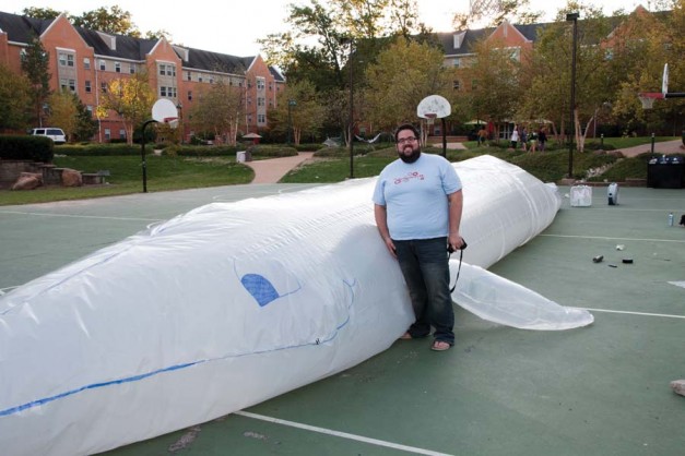 RuSoFo Residential College Director Andrew McDermott stands beside the RuSoFo whale that RAs made on Sunday to kick off Whale Week.