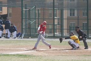 Kyle Billig conncets for a hit on Saturday against No.13 ranked College of St. Scholastica. The Bears upset  St. Scholastica 11-8. 