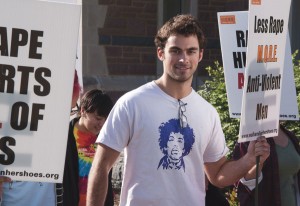 A variety of undergraduates carry signs in solidarity with the message of Walk a Mile in Her Shoes.