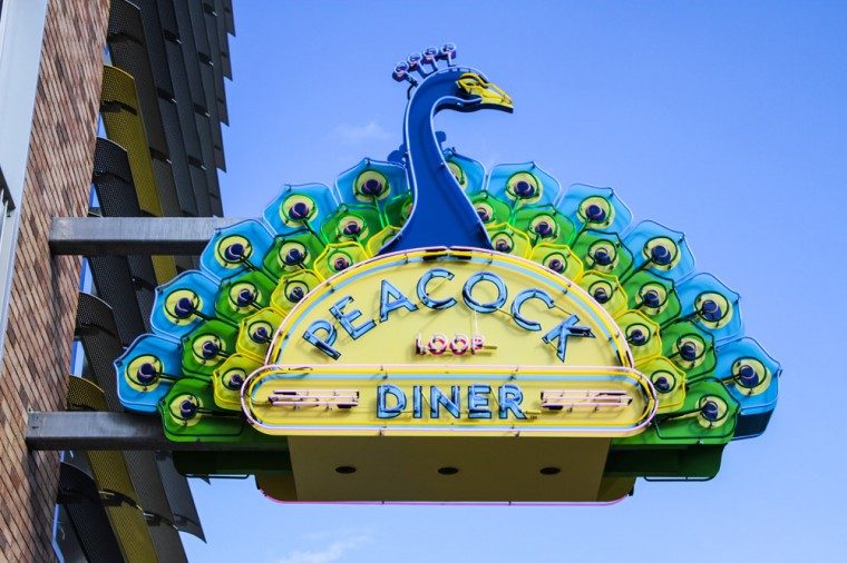 The sign for the Peacock Diner juts out above the sidewalk next to the Lofts of Washington University. The 24-hour diner is expected to open this weekend, just in time for parent visitors to campus.
