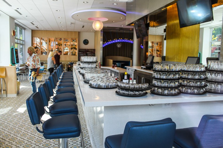 Joe Edwards, the owner of Blueberry Hill and other businesses on the Delmar Loop, walks through his new restaurant, the Peacock Diner, wearing a floral shirt.