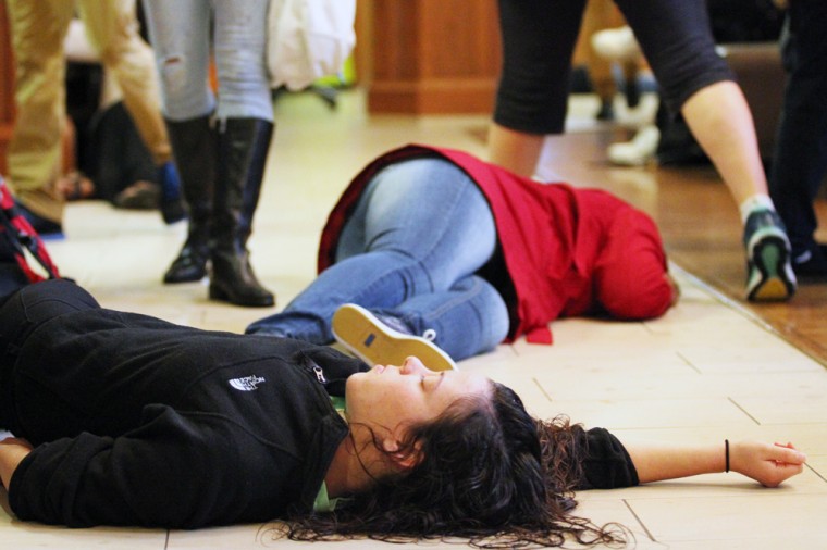 Two students lie on the ground in Tisch Commons as part of Monday’s “dead-in” demonstration. The event came as a follow-up to this past weekend’s Ferguson October rallies and protests in St. Louis.