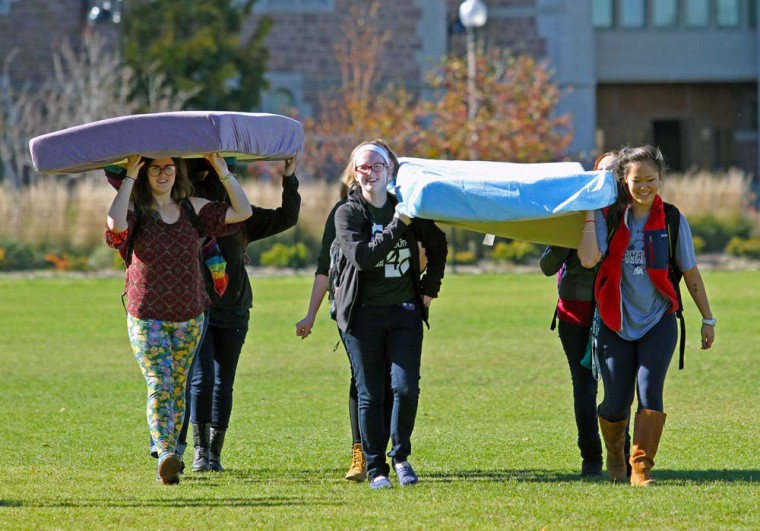 A group of students walk across Mudd Field carrying two mattresses. Wednesday’s event followed the lead of a student at Columbia University and aimed to show support for survivors of domestic and sexual violence.