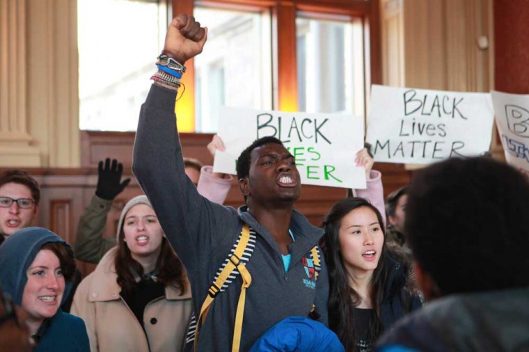 Undergraduates and social work students join to march through Brown Hall Monday afternoon, chanting in protest of recent events in Ferguson and racial discrimination among police officers.