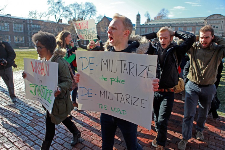 Student protesters march in Brookings Quadrangle Monday. A week after the announcement of a St. Louis County grand jury's decision not to indict officer Darren Wilson, students increased protest efforts on campus with two rallies. 