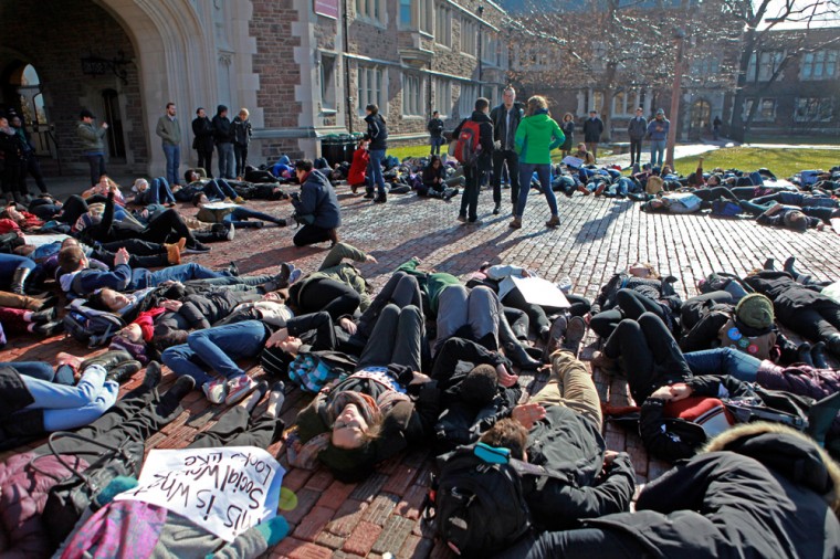 Protesters stage a die-in in the quad before event organizers urge Chancellor Mark Wrighton and the University community at large to take action in response to events in Ferguson.