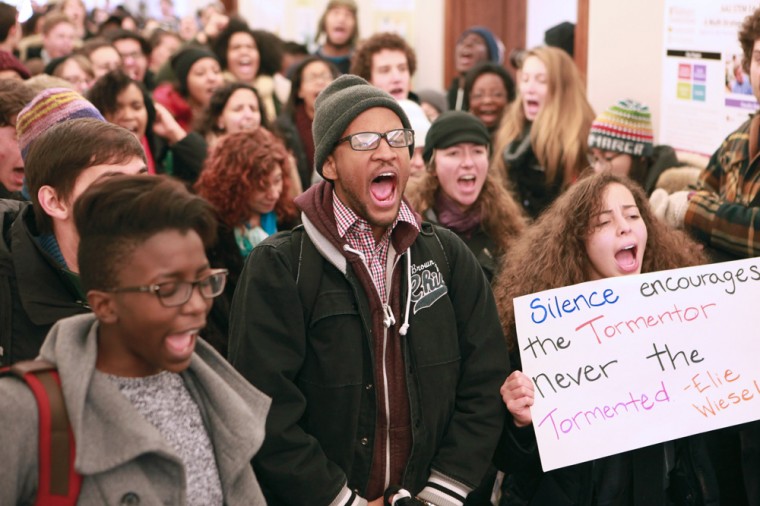 Undergraduates and social work students join to march through Brown Hall Monday afternoon, chanting in protest of police brutality and racial discrimination.