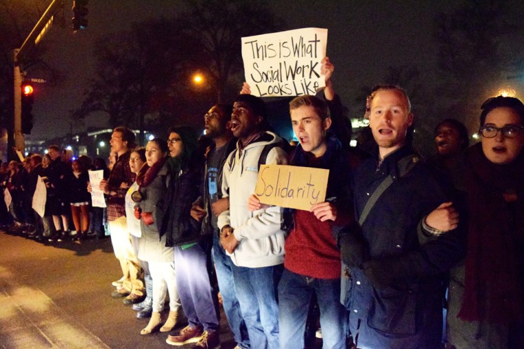 Protesters block the intersection of Forsyth and Skinker Boulevards on Thursday night, stopping traffic for around 20 minutes. Since returning from Thanksgiving break, students have increased their protest efforts against events in Ferguson.