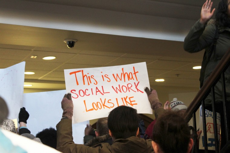 Participants in Monday afternoon's walkout included both undergraduates and graduate students, who carried signs and chanted about performing real-world social work.