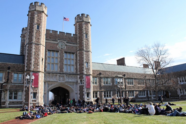 Event leaders stand in the middle of the crowd, urging their fellow students to take action and calling on Chancellor Mark Wrighton to respond to events in Ferguson.