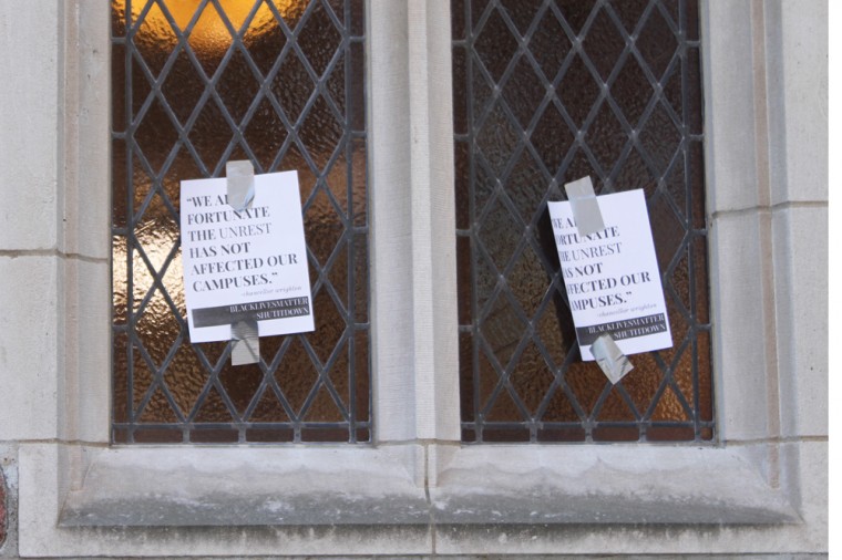 Posters quoting a campus-wide email sent by Chancellor Mark Wrighton are taped on windows around campus. Students referenced the quote in chants claiming that unrest has come to campus.