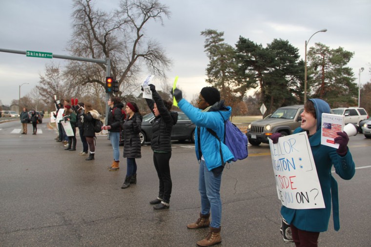 Student protesters block traffic at the intersection of Forsyth and Skinker Boulevards. The students then walked to Brookings Hall, where they demanded that the University give a public response to last week's grand jury decision not to indict police officer Darren Wilson.