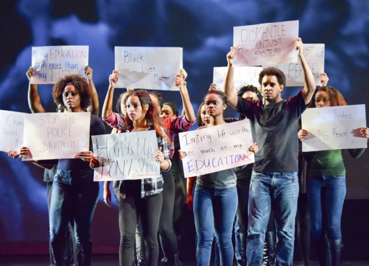 Black Anthology cast members hold up signs relating to the protests that swept the country and the St. Louis area last semester. In the play, the death of fictional Kevin Johnson in Ferguson under circumstances similar to the real-life death of Michael Brown sparked the protest movement.