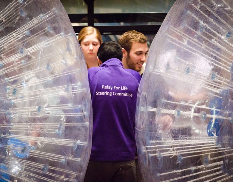 Members of Relay for Life huddle behind two human bowling balls at Saturday’s event. Relay teamed up with Mr. Wash. U. to put on the event as a replacement for the Vermonster challenge.