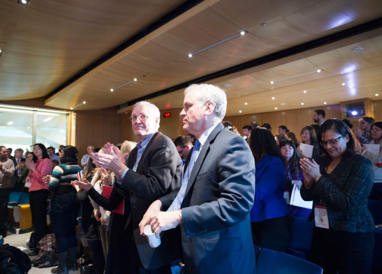 Delegates and audience members stand and applaud during the “Day of Dialogue” event on Friday. Four panels of administrators, faculty and students throughout the day discussed various facets of the issue of racial inequality on campus and in the St. Louis community and ways to combat those problems.