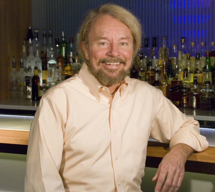 Joe Edwards sits at a bar in Blueberry Hill, his flagship restaurant on the Delmar Loop.