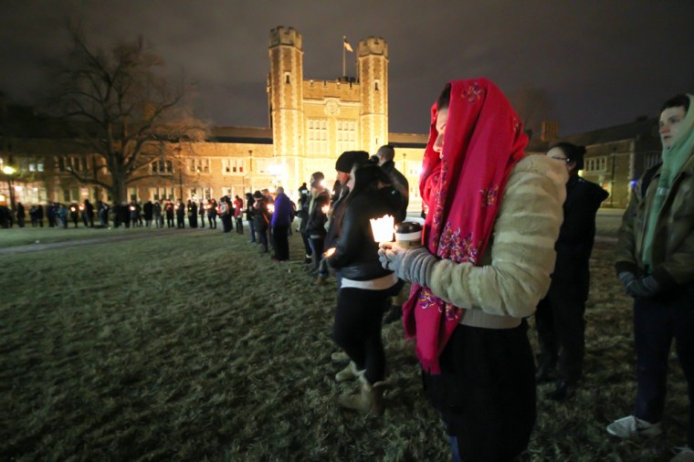 Students and community members hold candles to remember the lives of three Muslim students from Chapel Hill, N.C., who were killed last week. The murders sparked outrage online, summed by the hashtag #MuslimLivesMatter, and led to students filling Brookings Quadrangle in their memory.