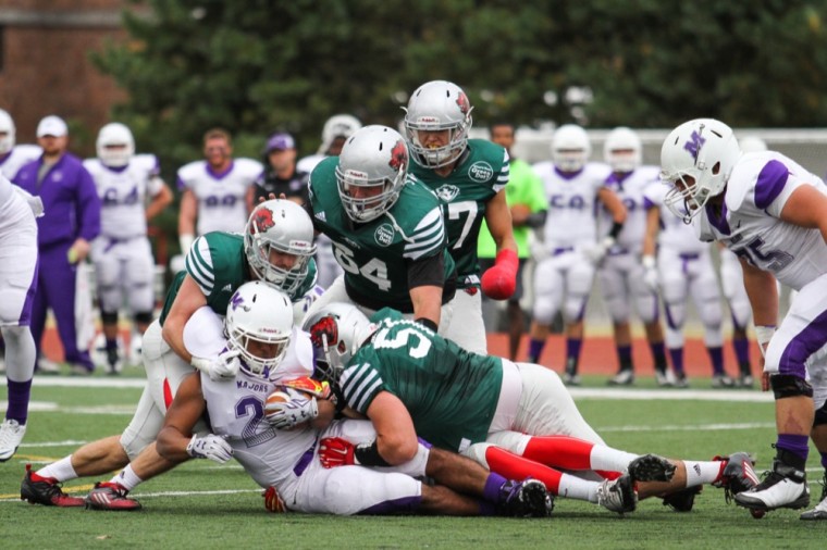The Washington University defense tackles a Millsaps College ballcarrier in the first quarter Saturday. The Bears won 70-32 as junior quarterback J.J. Tomlin reached 4,000 career passing yards.
