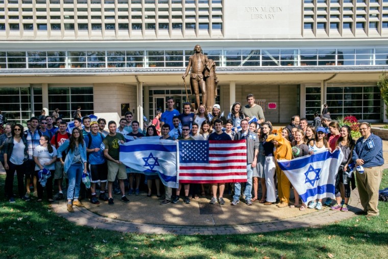 A group of students supporting Israel poses in front of the George Washington statue on campus as part of a rally of support. In the past few weeks, violence has encouraged students to advocate for peace in the region.
