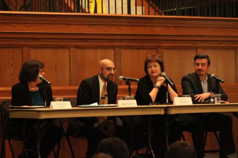 Panelists discuss what classifies someone as a refugee during the beginning of the “In a Strange Land: The Refugee Experience in the United States” panel on Thursday evening in the DUC’s Tisch Commons. The event was sponsored by Sigma Iota Rho Honor Society.