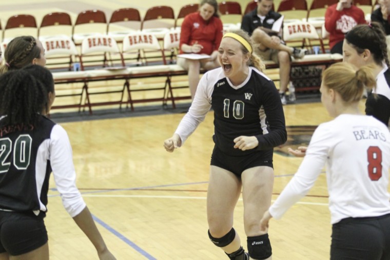Senior setter Allison Zastrow celebrates after winning against the University of Wisconsin-Oshkosh on Sept. 5, 2015.  Zastrow ranks second in Division III in assists per set this season.