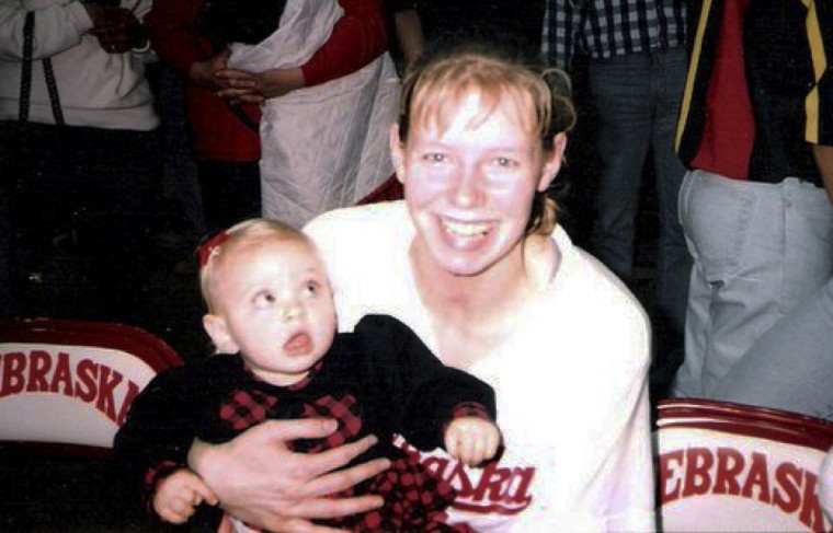 Senior Allison Zastrow (left) sits in the lap of University of Nebraska volleyball great Allison Weston in 1994. Zastrow’s parents have season tickets to Nebraska volleyball, and they named their daughter after the Cornhuskers’ best player.
