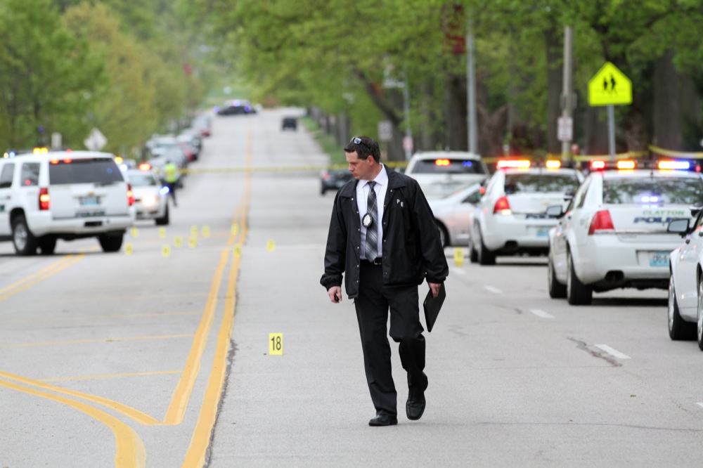 An officer surveys Forsyth Boulevard after the shooting on April 20. The Danforth Campus was put on lockdown from approximately 1:30 p.m. to 2:46 p.m. following the shooting.