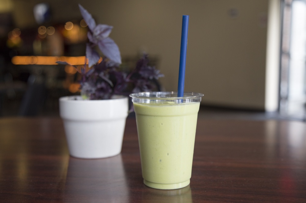 The green mango supreme smoothie sits on a table at It’s A Wrap.