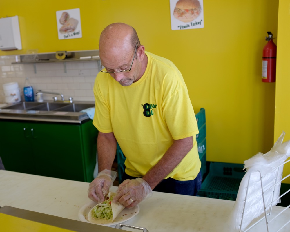 An $8 sandwich is prepared at 8 Dollar Deli. The restaurant, which has evolved from its food truck origins, just opened in the former Smoothie King location on the Delmar Loop.
